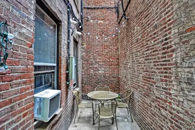 A small outdoor patio area with a table and chairs, perfect for enjoying the fresh air.