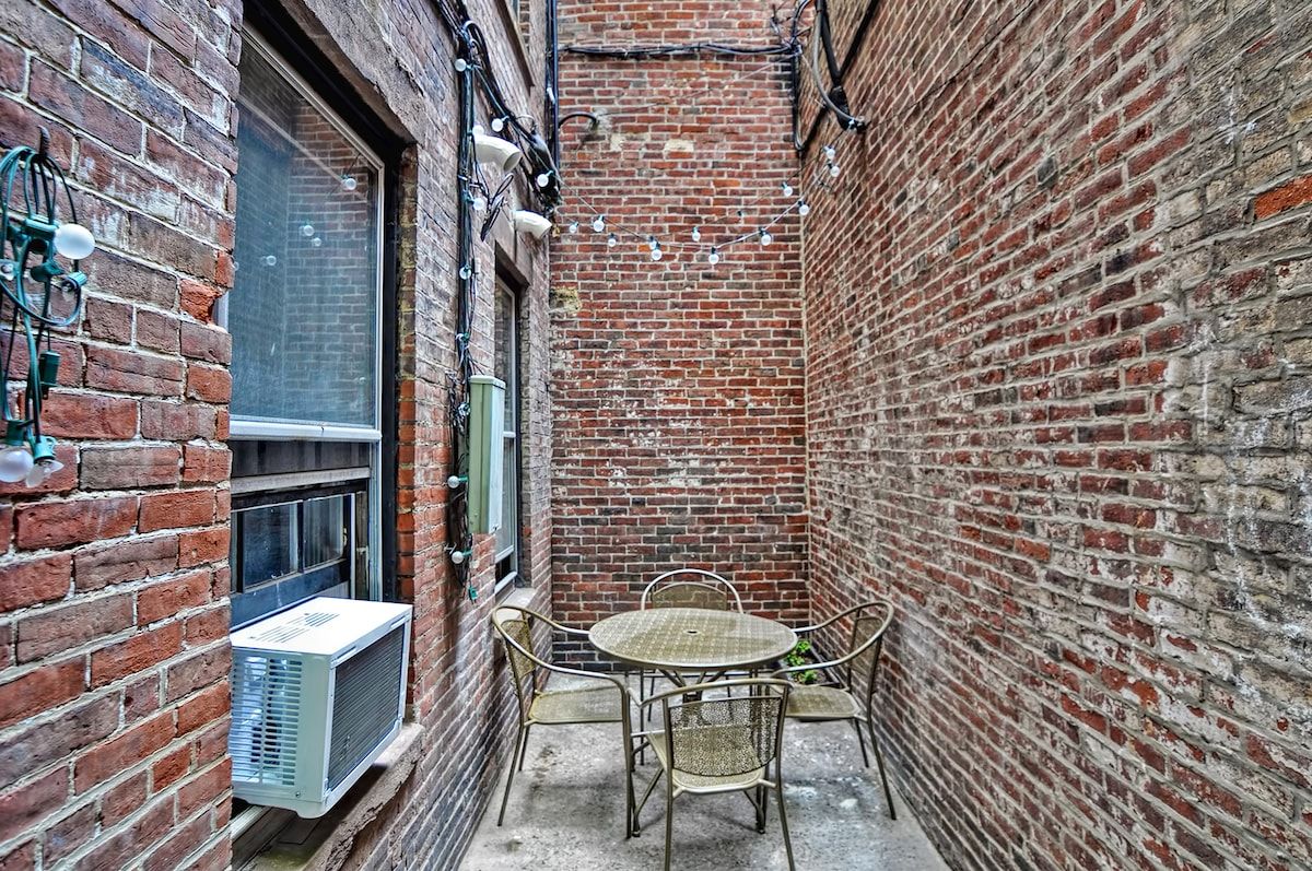 A small outdoor patio area with a table and chairs, perfect for enjoying the fresh air.