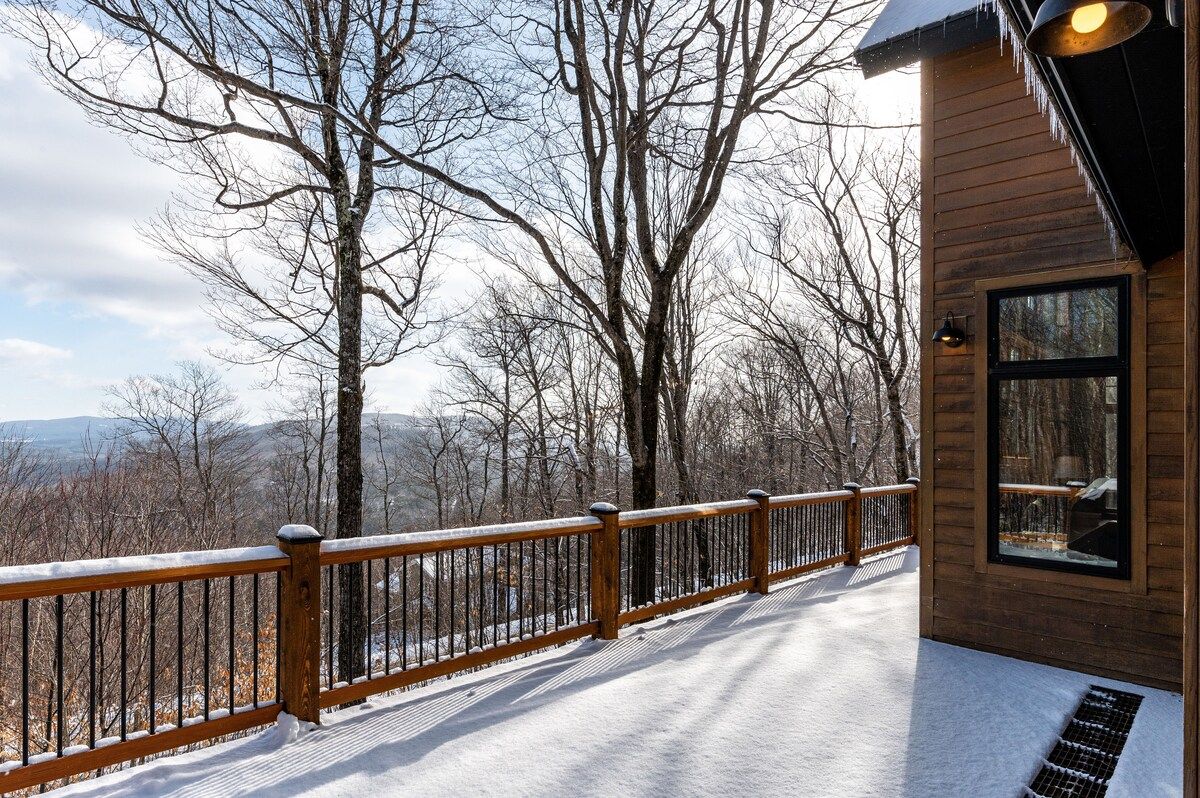 Snowy deck with a view of the mountains