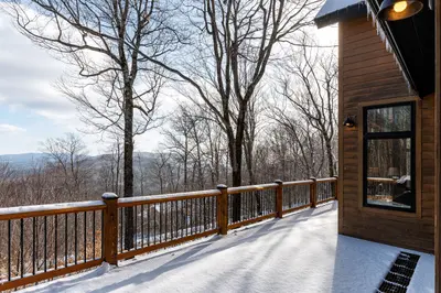 Snowy deck with a view of the mountains