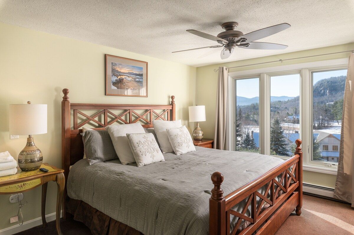 Spacious master bedroom with king bed and mountain views
