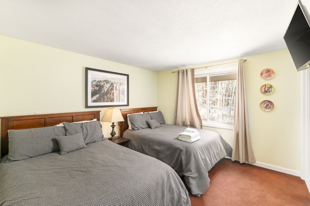 Spacious master bedroom with king bed and mountain views