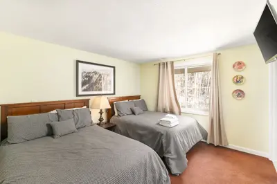 Spacious master bedroom with king bed and mountain views