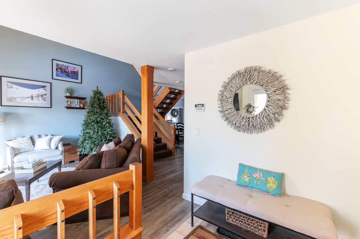 Cozy living room with a Christmas tree and comfortable seating area